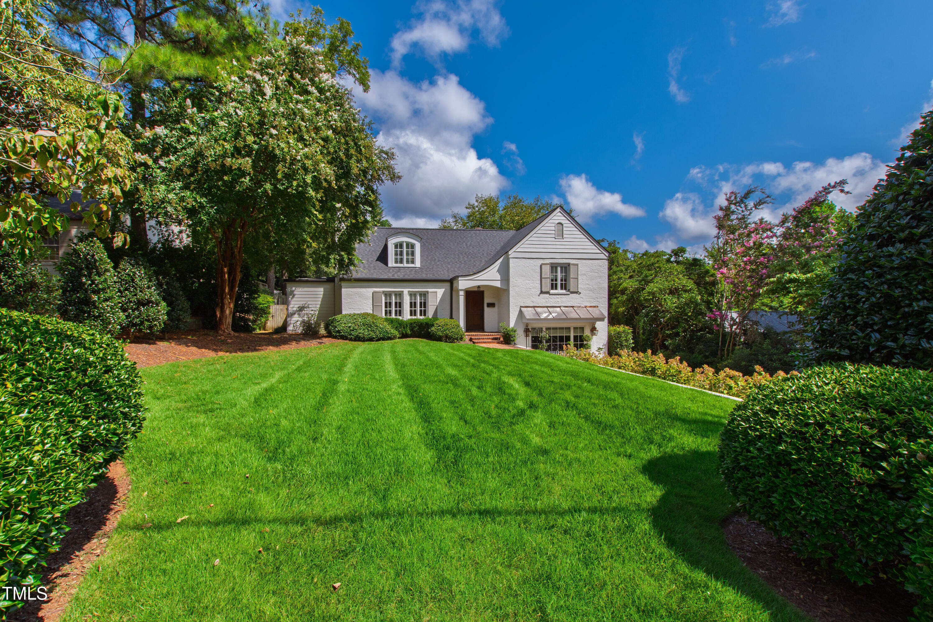 2610 Wells Avenue Raleigh, NC 27608 - Photo 2 of 64 a front view of a house with garden