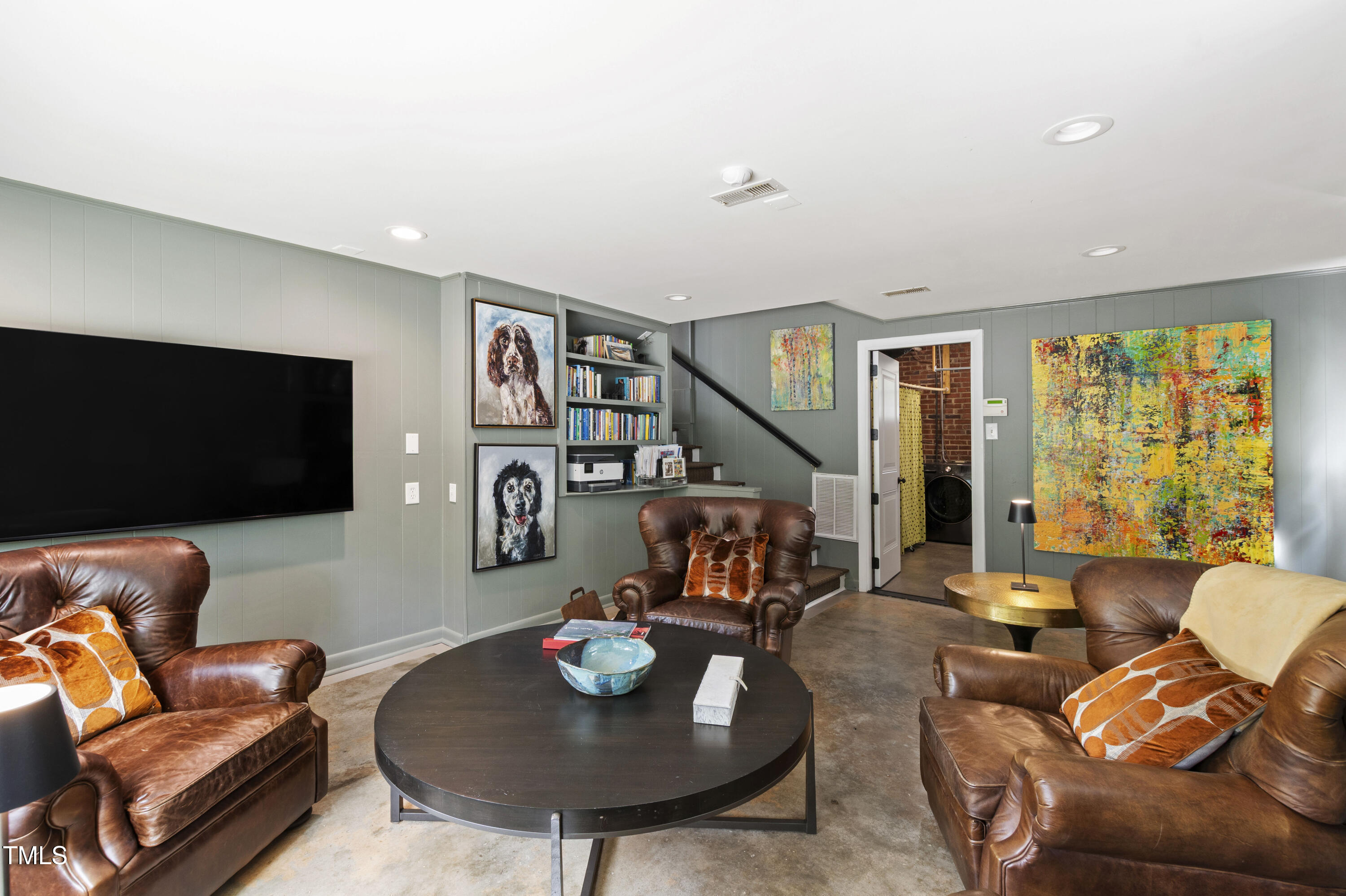 2610 Wells Avenue Raleigh, NC 27608 - Photo 31 of 64 a living room with furniture and a flat screen tv