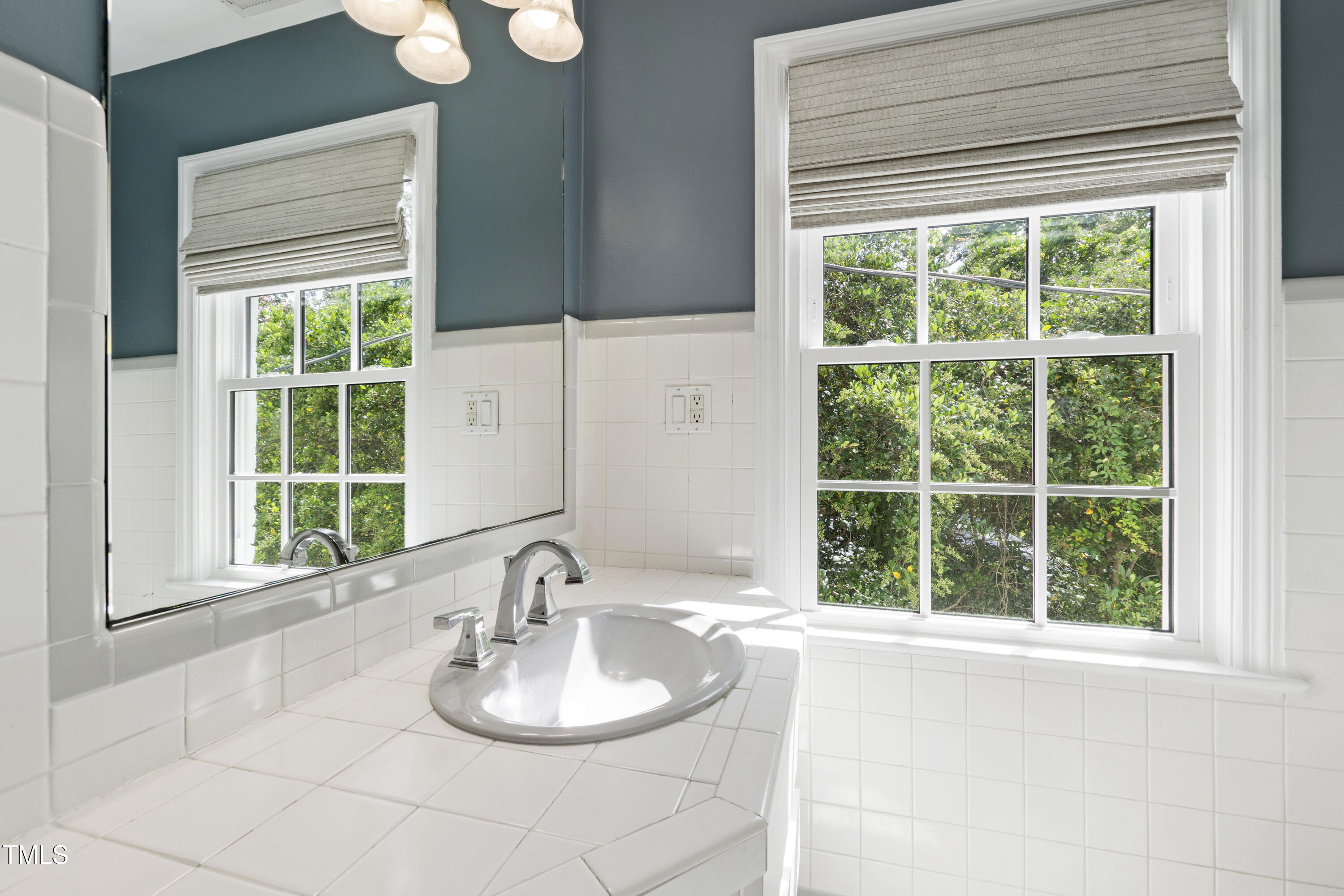 2610 Wells Avenue Raleigh, NC 27608 - Photo 44 of 64 a bathroom with a sink and a window