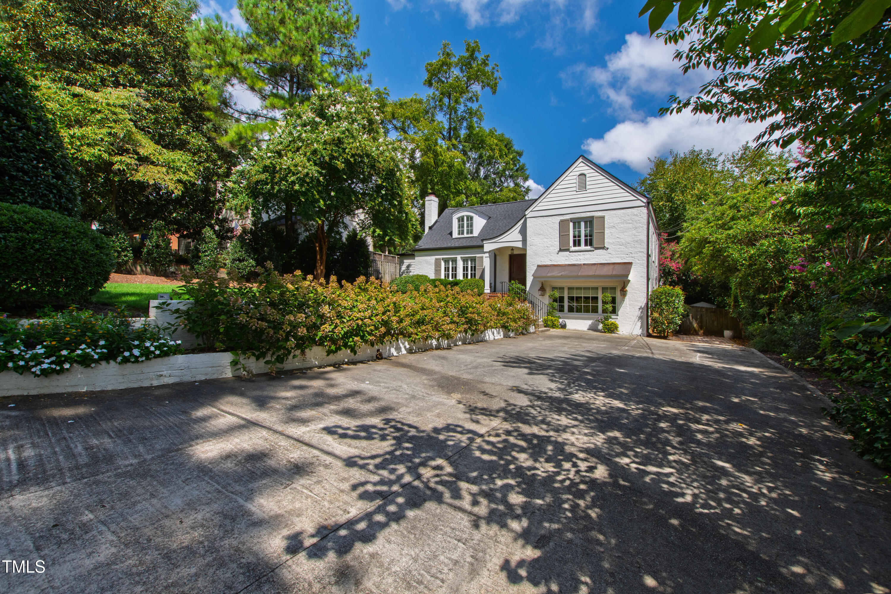 2610 Wells Avenue Raleigh, NC 27608 - Photo 64 of 64 a front view of a house with a yard and a garden