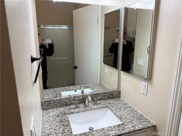 a bathroom with a sink toilet and cabinets