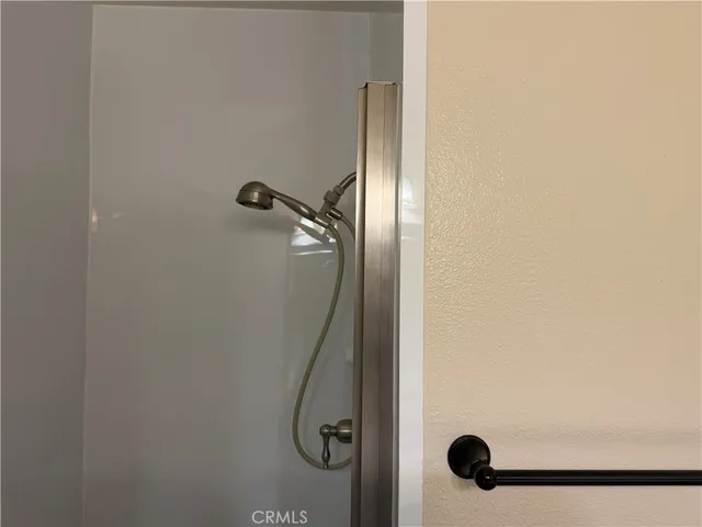 a view of an empty room with cabinet and a window