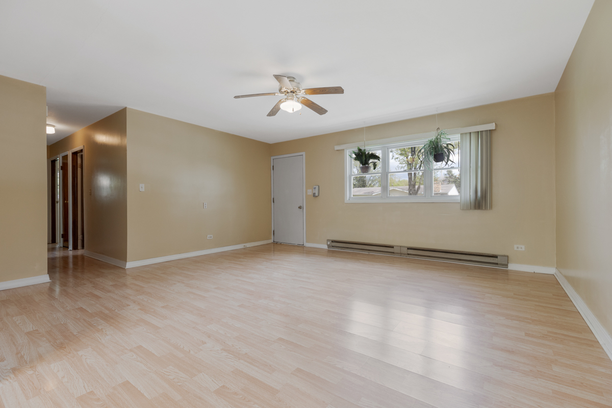 425 Dunbar Road Wauconda, IL 60084 - Photo 3 of 17 wooden floor in an empty room with a window