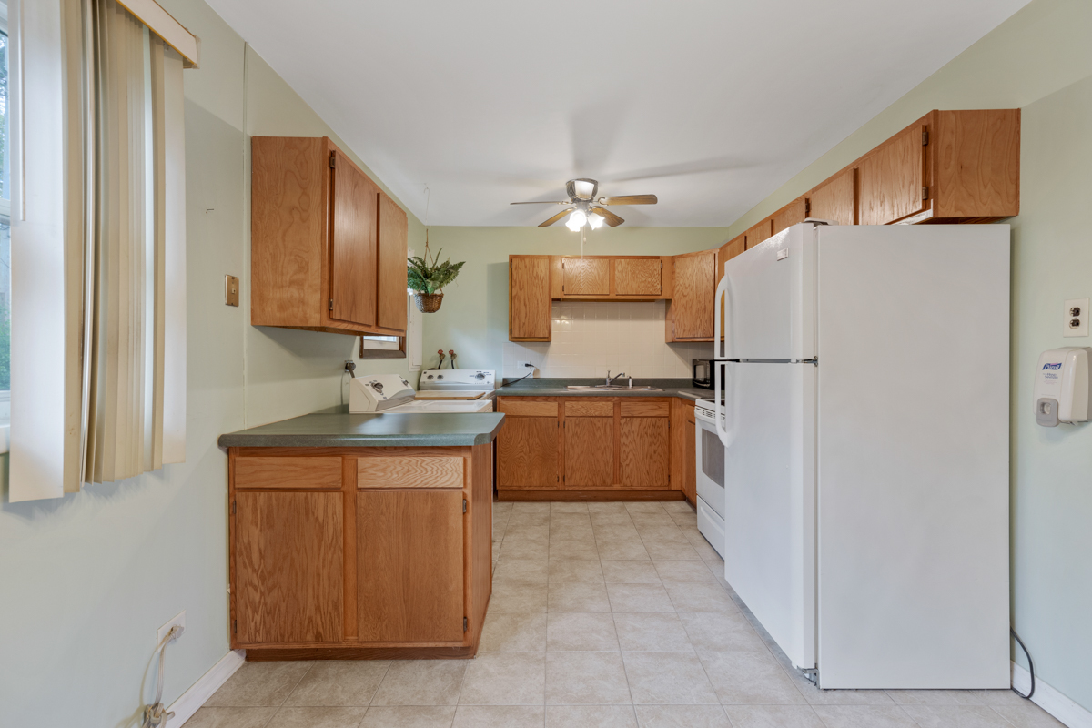 425 Dunbar Road Wauconda, IL 60084 - Photo 8 of 17 a kitchen with a sink a refrigerator and a stove
