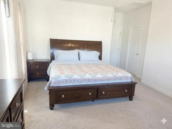 a bed sitting in a bedroom next to a window