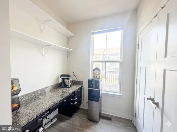 a kitchen with granite countertop cabinets and window