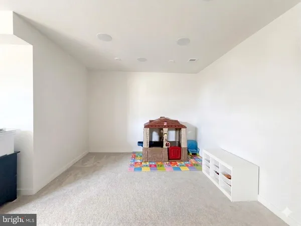 a hallway with kids room with toys
