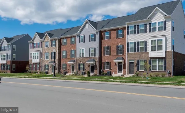 front view of a brick building next to a yard