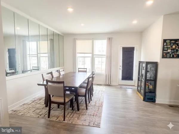 a view of a a dining room with furniture window and wooden floor