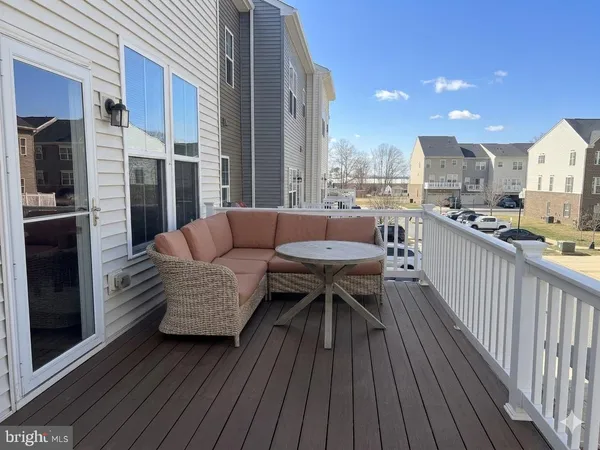 a patio with patio couch and outdoor seating