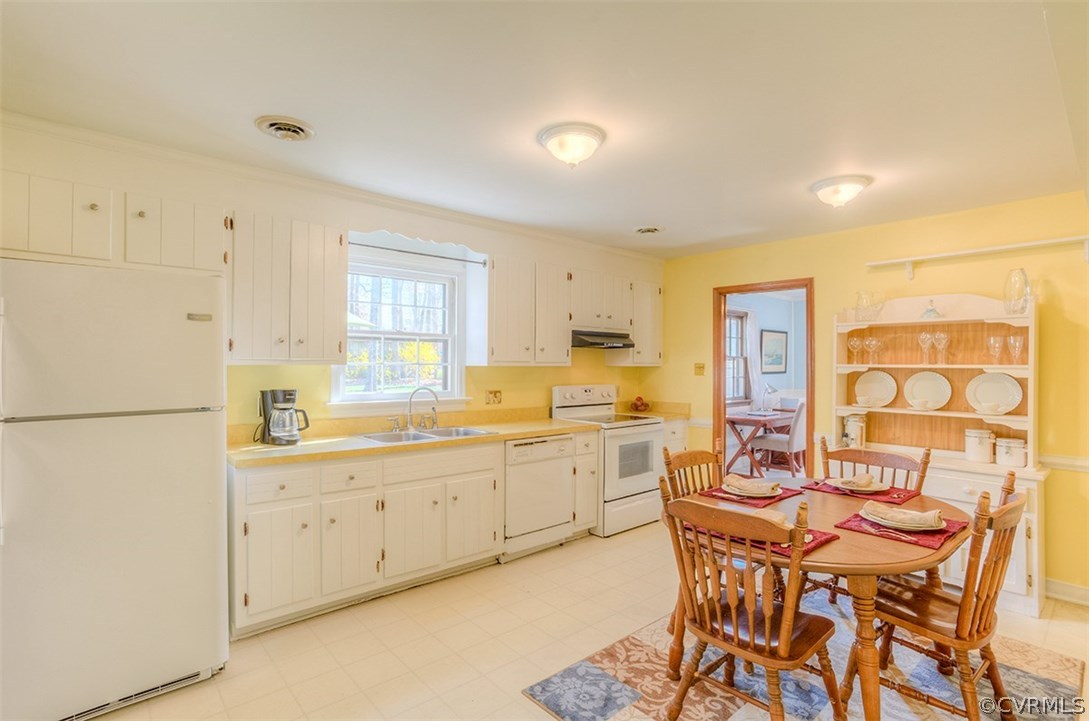 4716 Wedgemere Road Chesterfield, VA 23832 - Photo 8 of 18 a kitchen with stainless steel appliances granite countertop a dining table chairs and a refrigerator