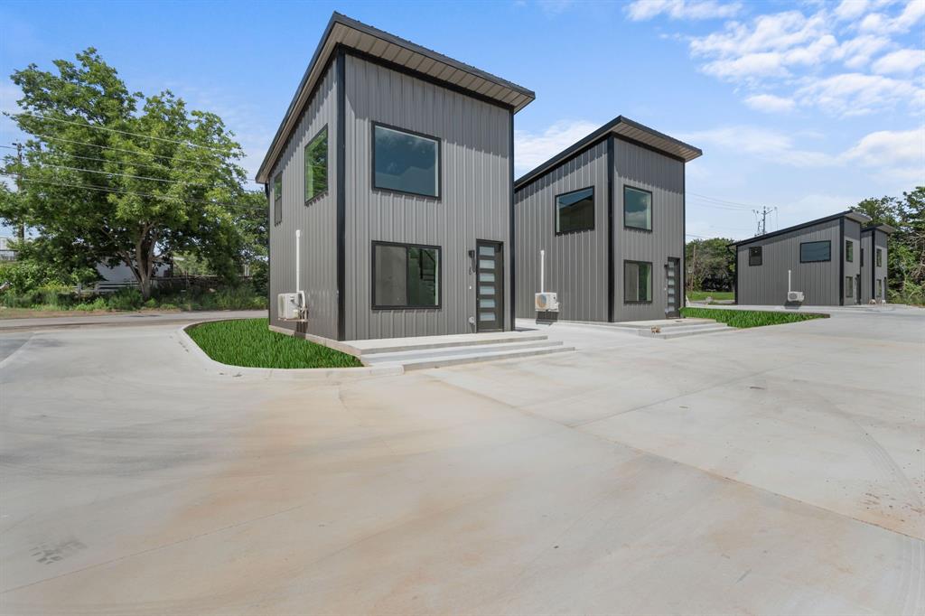 802 Old Wise Road, Unit 23 Bowie, TX 76230 - Photo 1 of 22 a front view of a house with a yard and garage
