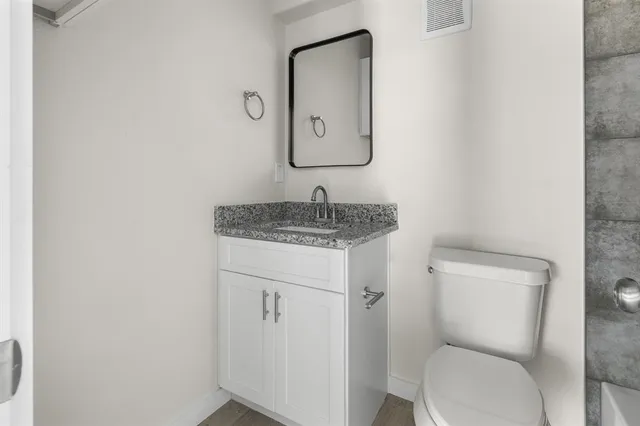 a bathroom with a bathtub and a toilet