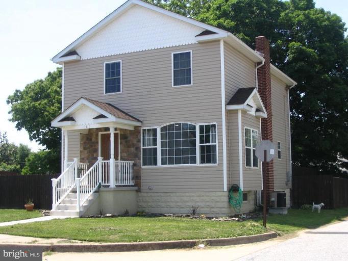 3116 Green Hill Road Sparrows Point, MD 21219 - Photo 1 of 6 a front view of a house with a yard and trees