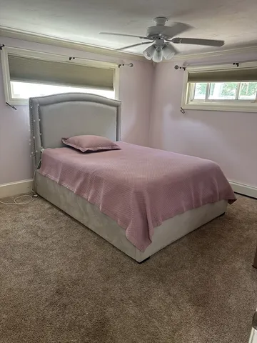 a bedroom with a bed and window