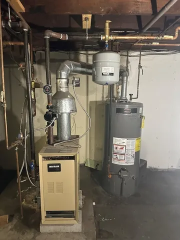 a view of water heater room with washer and dryer