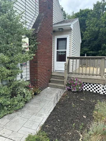 a view of a wooden door with a bench