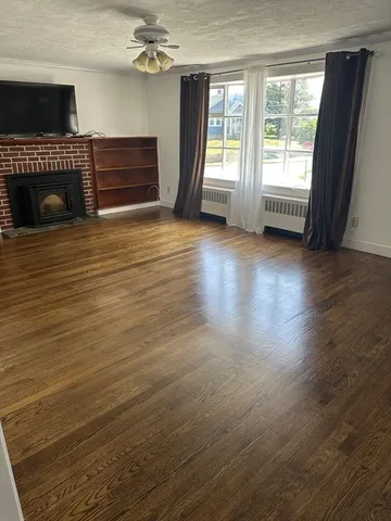 a view of a livingroom with furniture and staircase