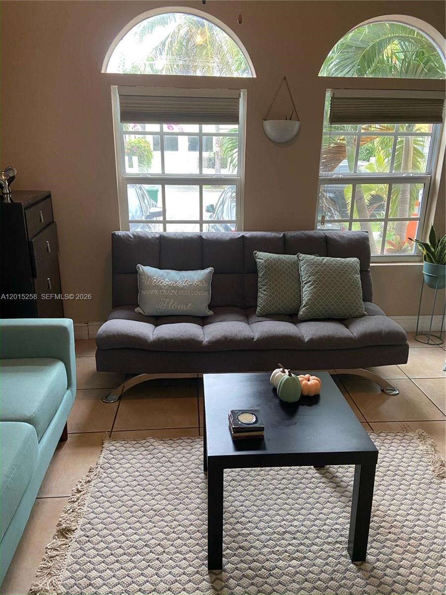 1678 Southwest 11th Street, Unit STUDIO Miami, FL 33135 - Photo 3 of 9 a living room with furniture and a window