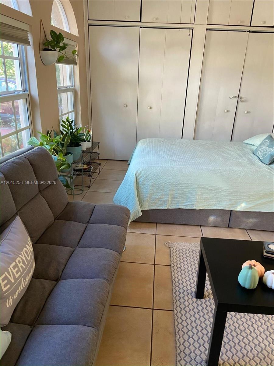 1678 Southwest 11th Street, Unit STUDIO Miami, FL 33135 - Photo 6 of 9 a bedroom with a bed and window