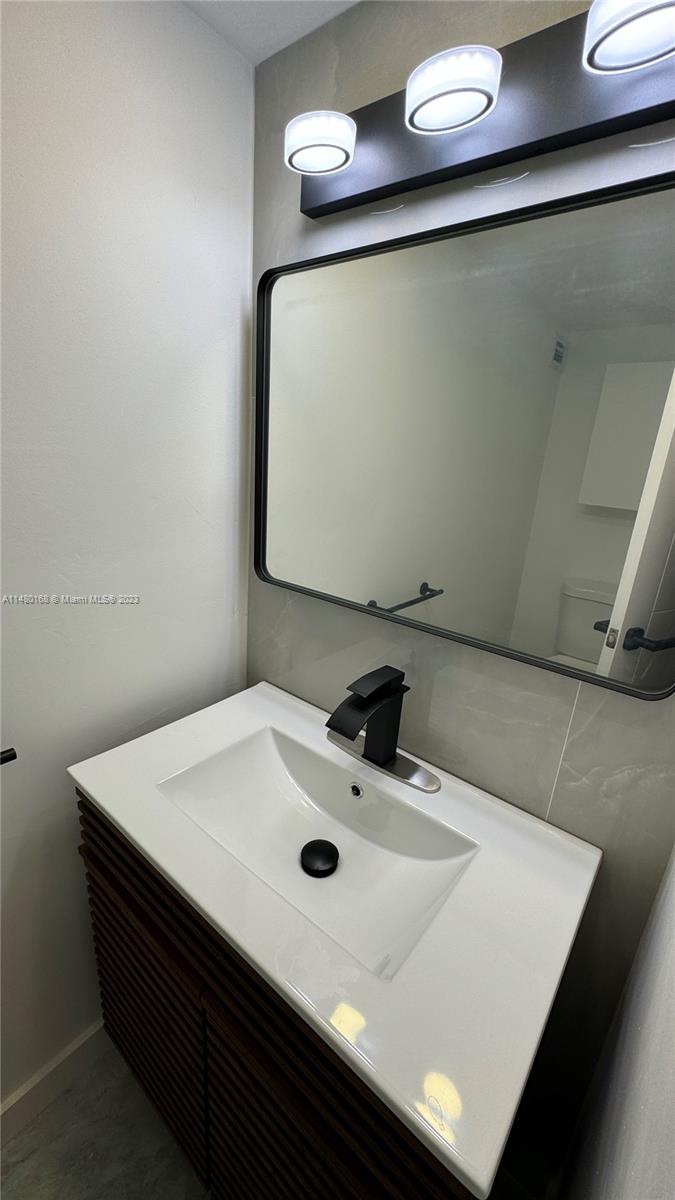 Brickell Biscayne Condominiums Miami, FL 33129 - Photo 11 of 12 a bathroom with a sink and a mirror