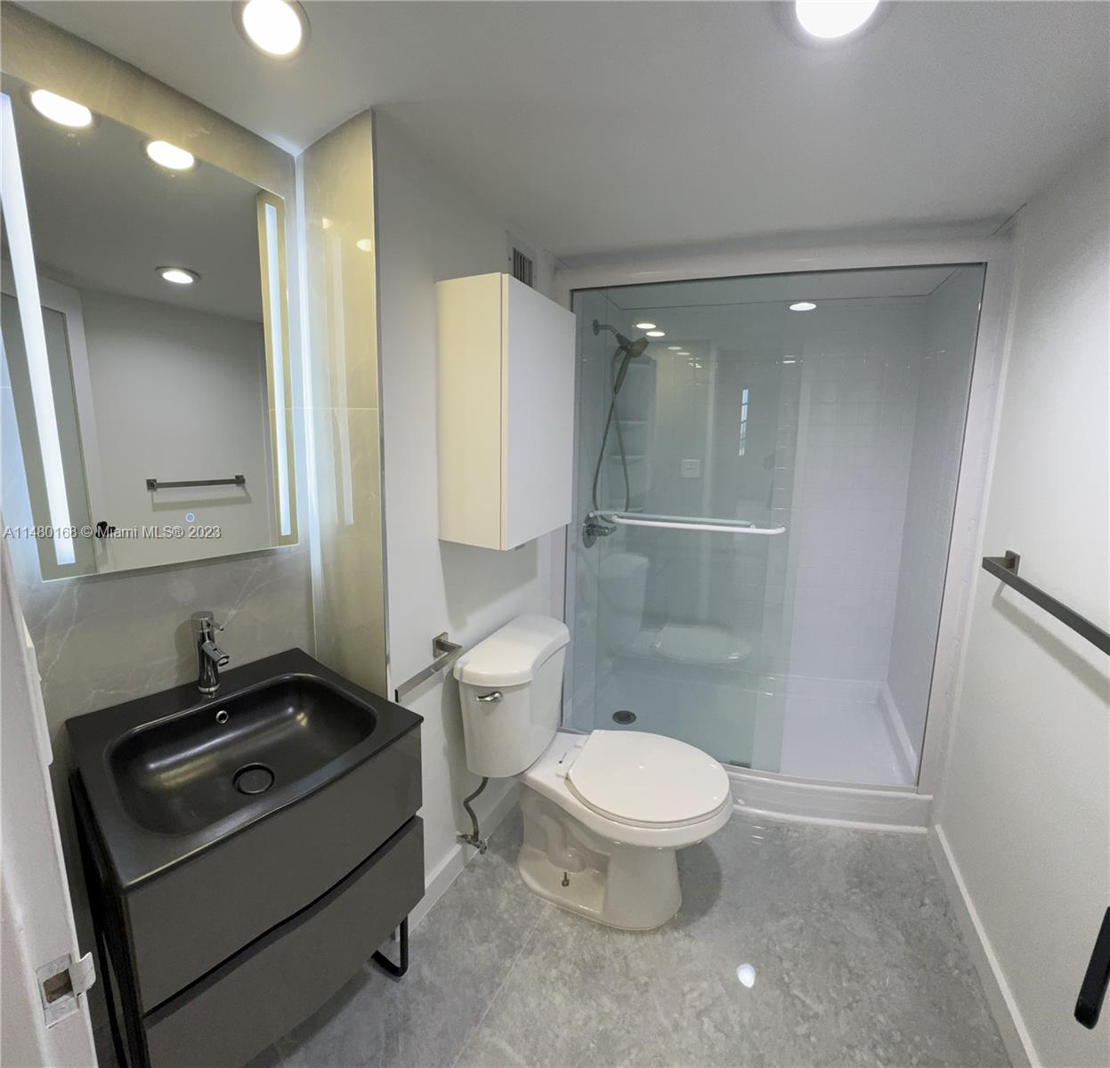 Brickell Biscayne Condominiums Miami, FL 33129 - Photo 6 of 12 a bathroom with a sink a toilet a mirror and shower