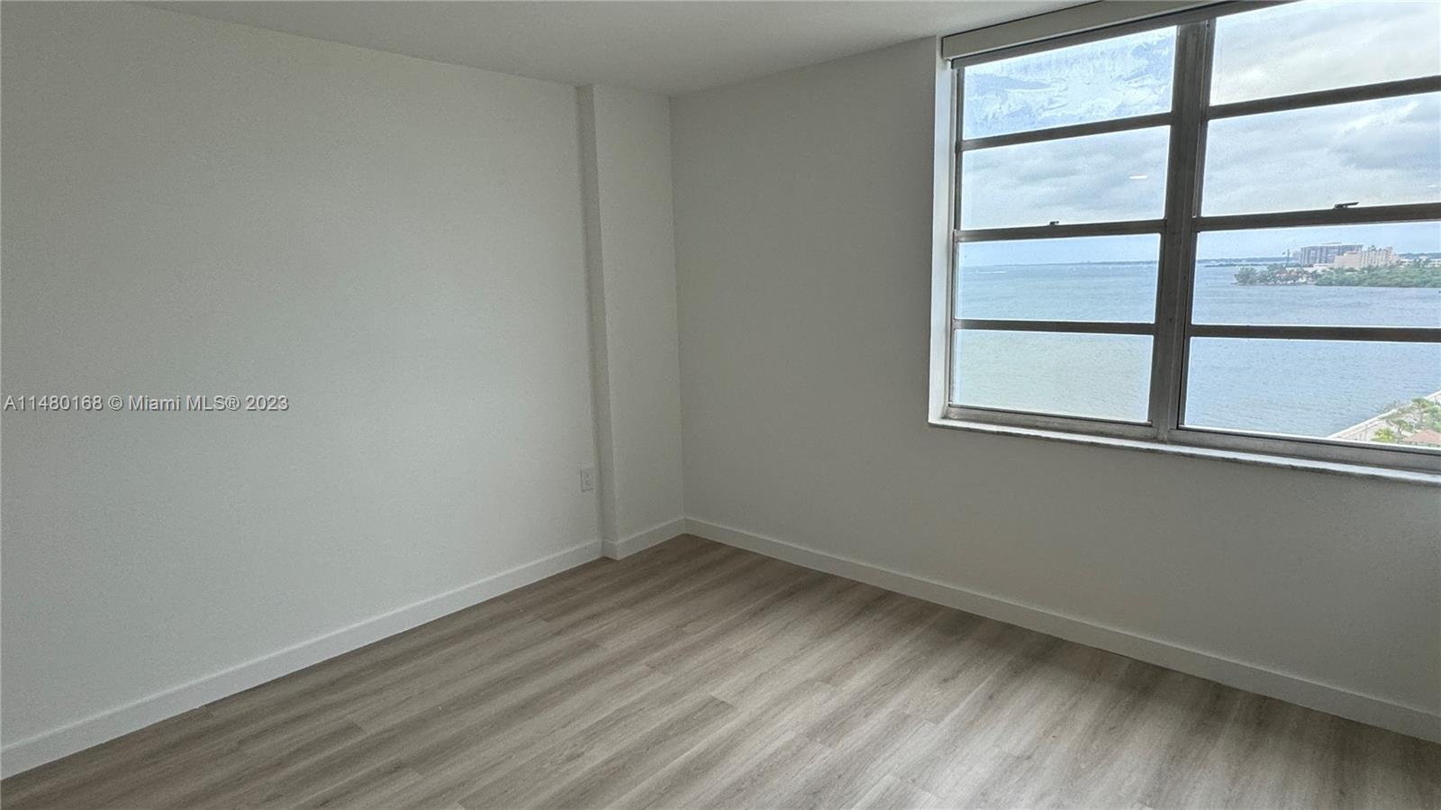 Brickell Biscayne Condominiums Miami, FL 33129 - Photo 8 of 12 wooden floor in an empty room with a window