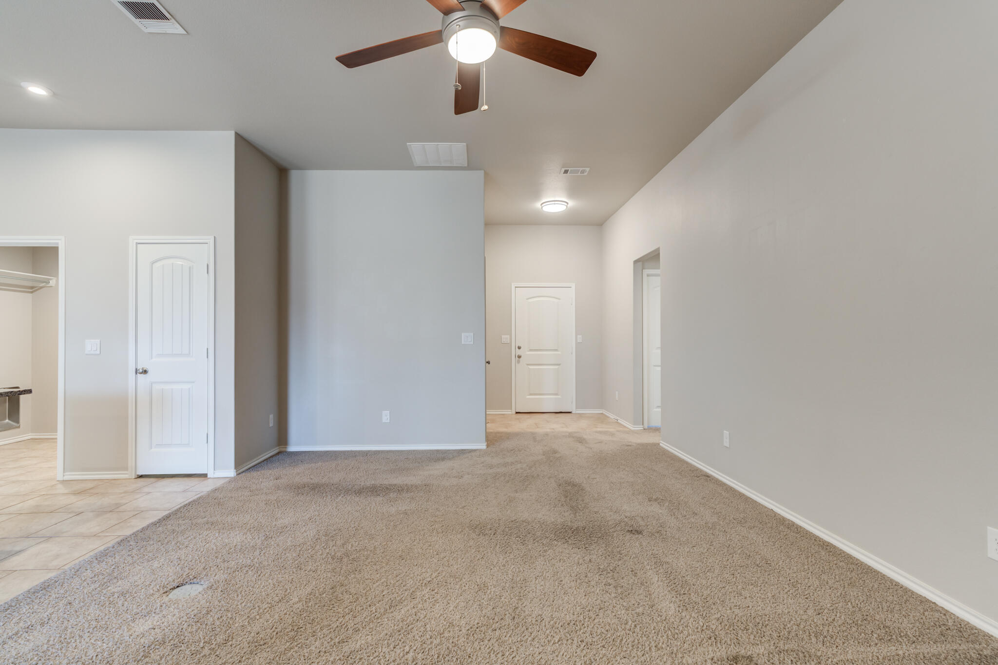 7519 101st Street Lubbock, TX 79424 - Photo 23 of 44 an empty room with closet and a chandelier fan
