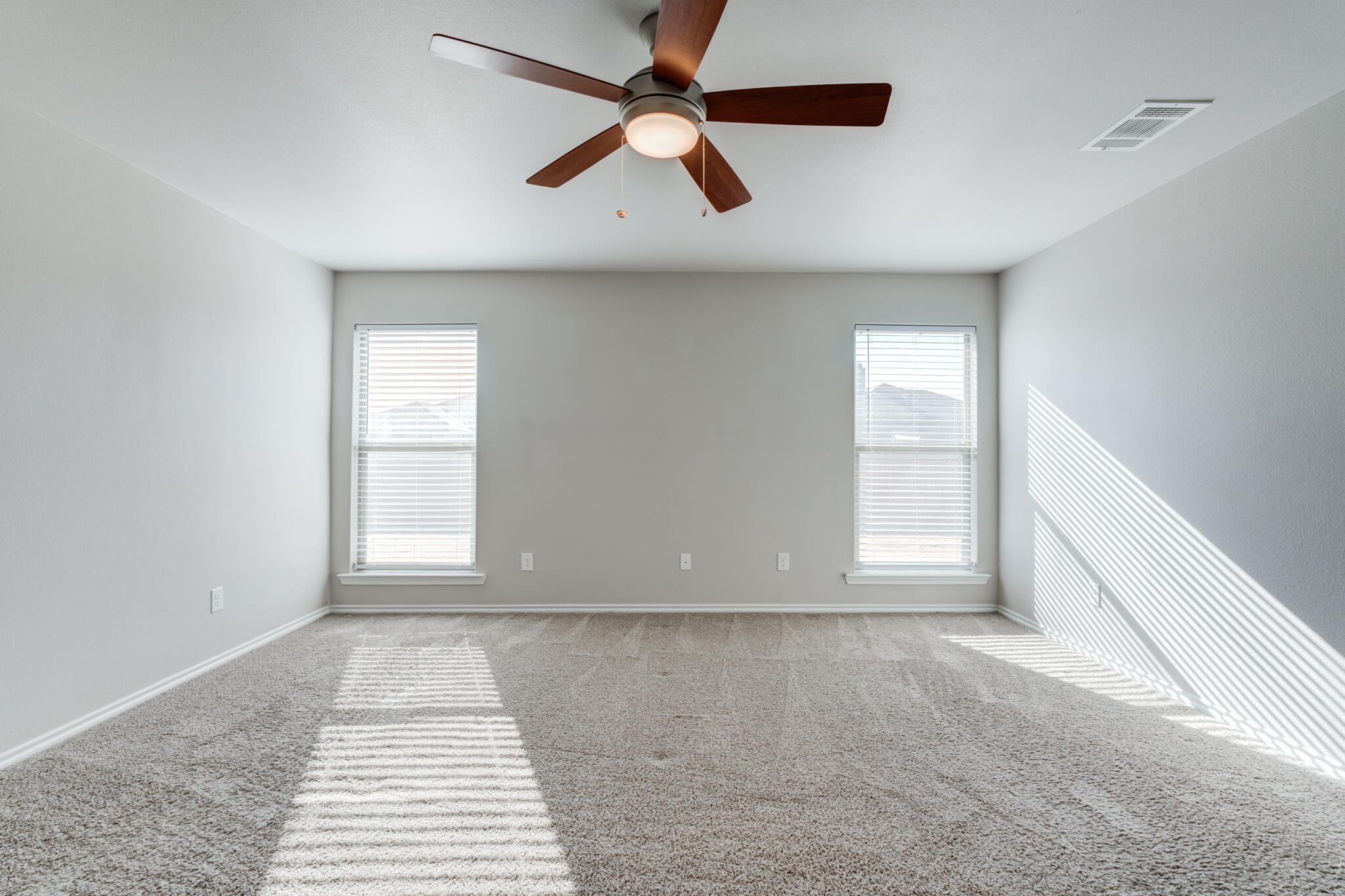 7519 101st Street Lubbock, TX 79424 - Photo 28 of 44 an empty room with windows and ceiling fan