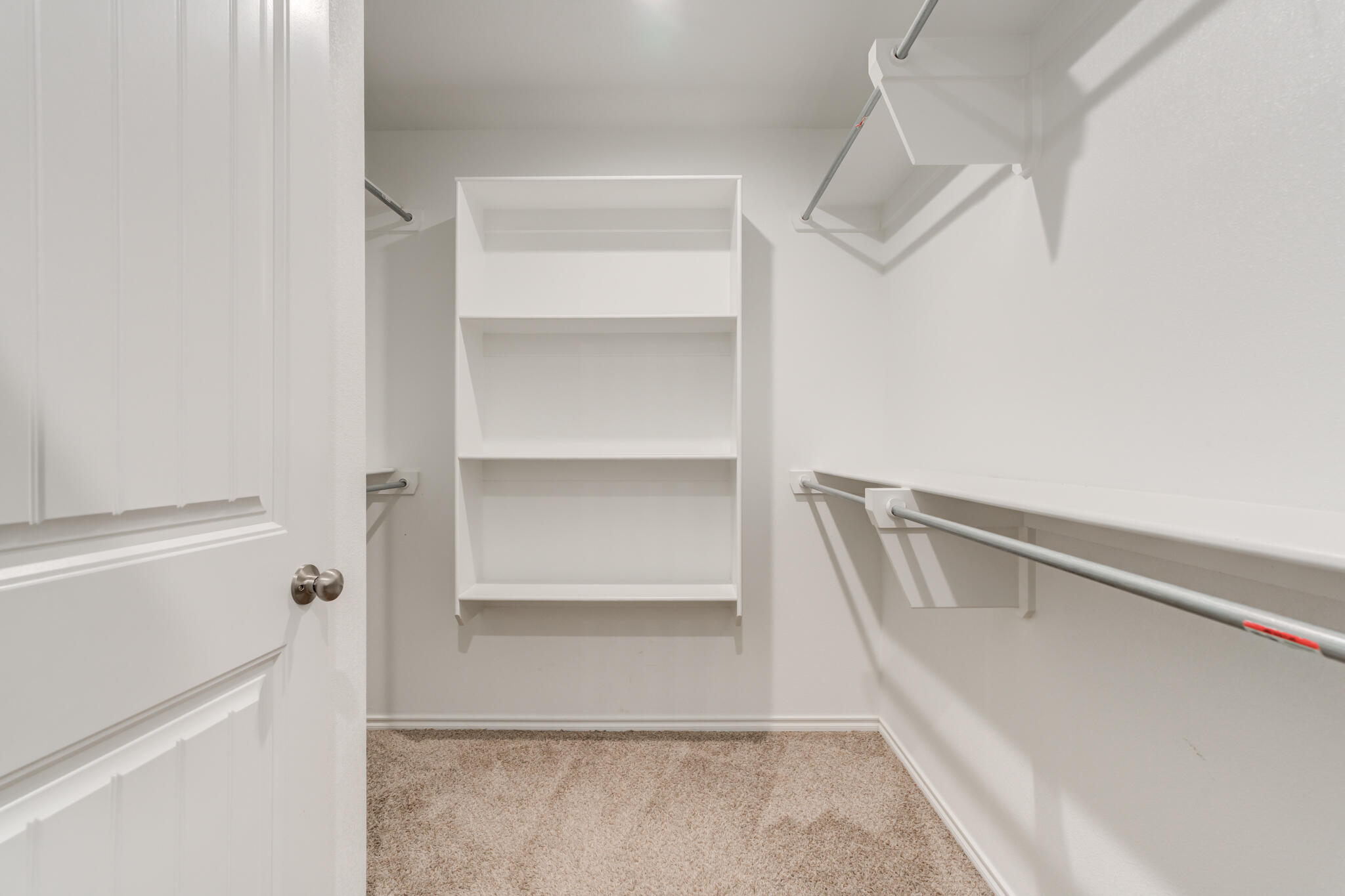 7519 101st Street Lubbock, TX 79424 - Photo 34 of 44 a view of walk in closet with empty racks