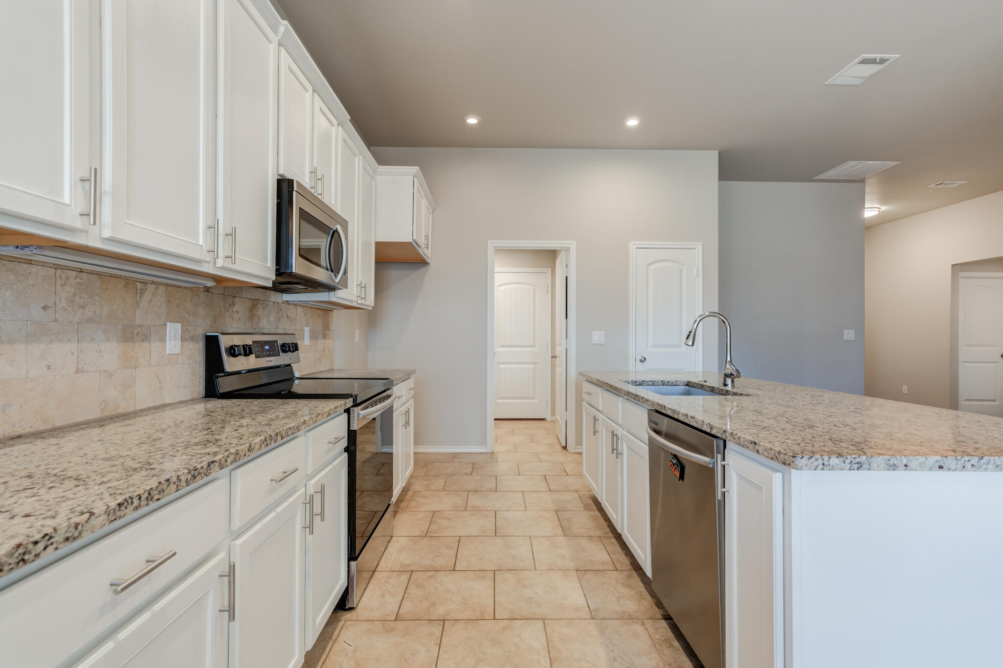 7519 101st Street Lubbock, TX 79424 - Photo 8 of 44 a large kitchen with stainless steel appliances granite countertop a granite counter tops and a stove