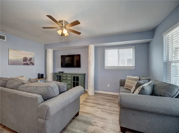 a living room with furniture and a flat screen tv
