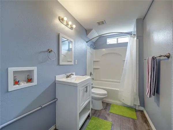 a bathroom with a sink toilet and shower