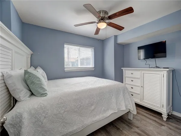 a bedroom with a large bed and a flat screen tv