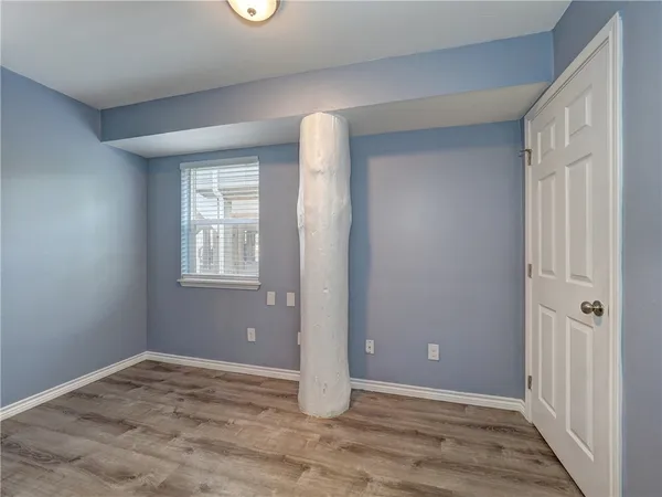 an empty room with windows and closet