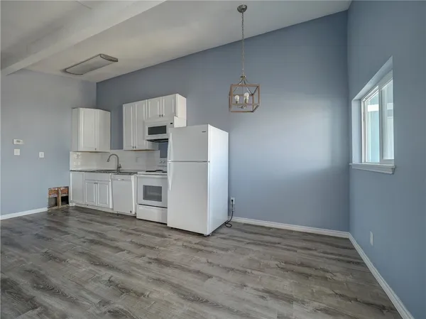a view of kitchen with wooden floor