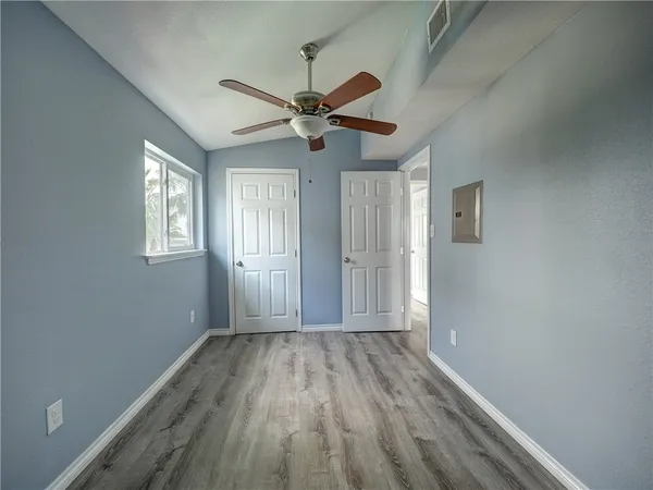 wooden floor in an empty room with a window