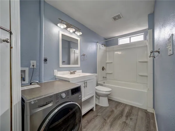 a view of a bathroom with a sink a toilet and shower
