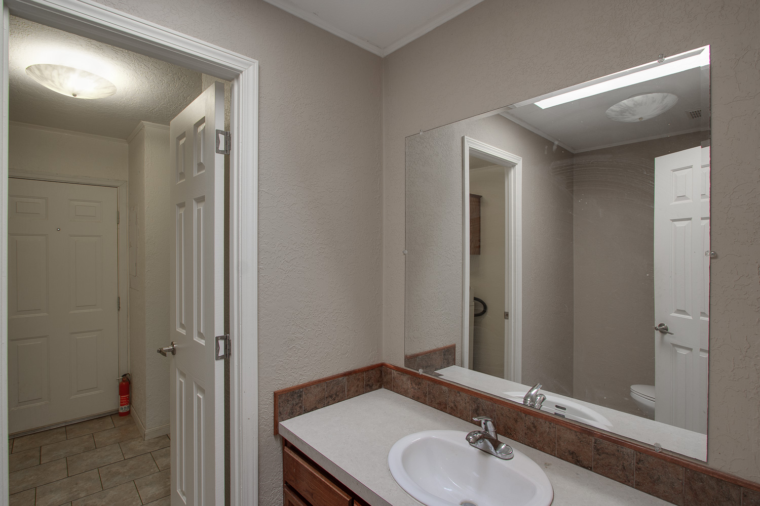 133 Mark Adams Road Del Valle, TX 78617 - Photo 16 of 20 Clean lines and a spacious mirror define this updated vanity area.