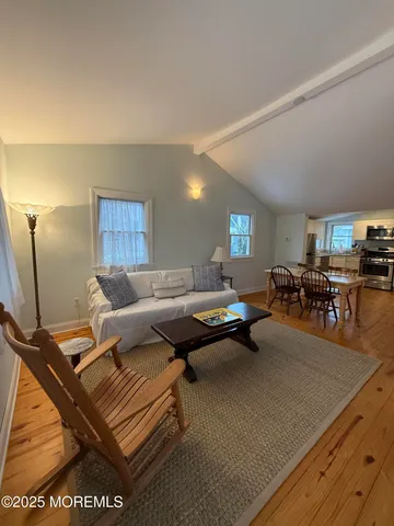 a living room with furniture a table and a flat screen tv