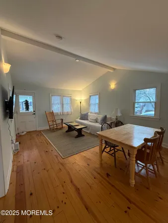 a living room with furniture a table and chairs