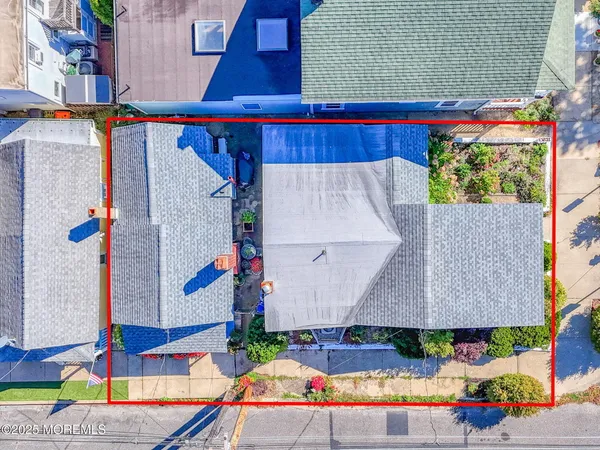 an aerial view of a house with a yard and outdoor seating