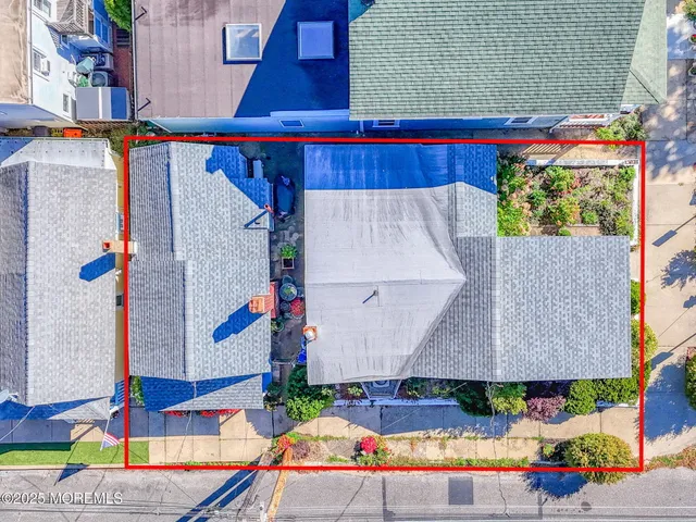 an aerial view of a house with a yard and outdoor seating
