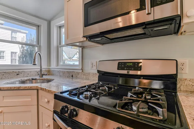 a kitchen with a stove and a sink