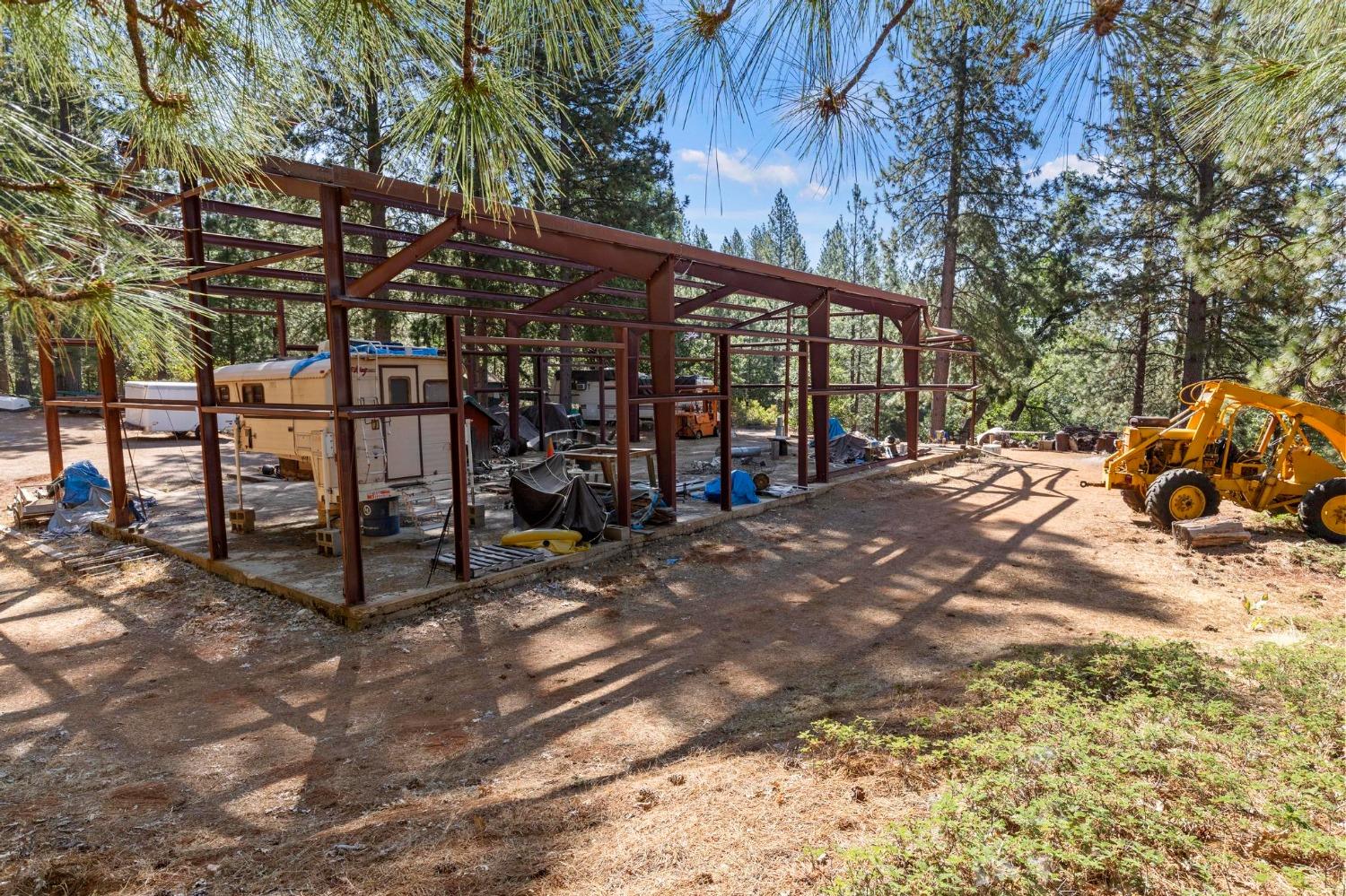 25251 Canterbury Road Pioneer, CA 95666 - Photo 19 of 33 a view of a backyard with wooden fence and a bench