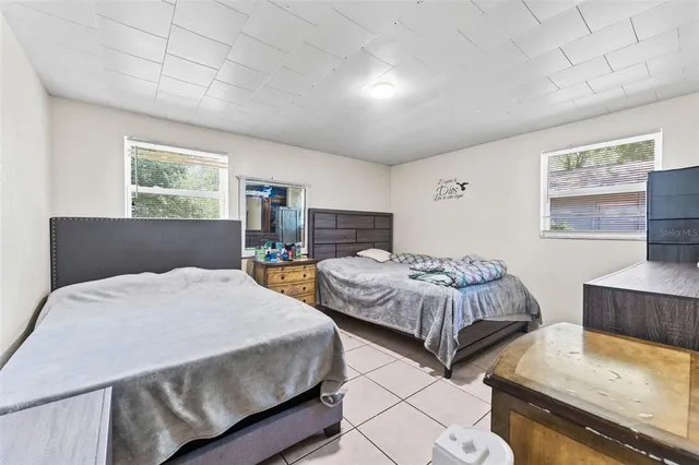 a bedroom with bed and a window