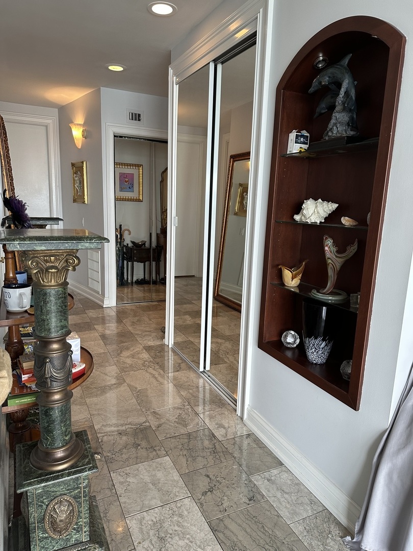 860 North Lake Shore Drive, Unit 5M Chicago, IL 60611 - Photo 10 of 11 a kitchen with stainless steel appliances granite countertop a refrigerator and a stove