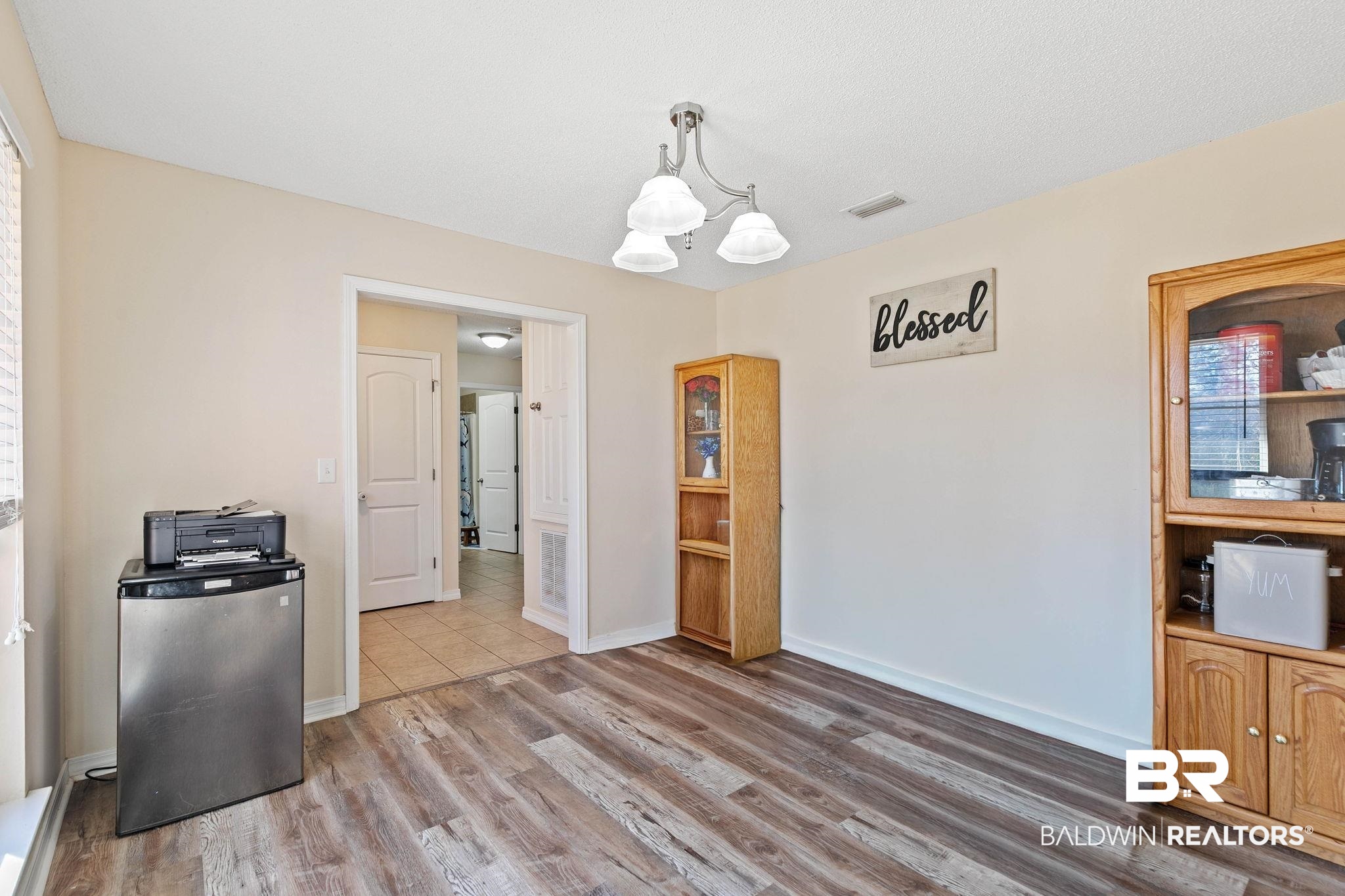 55750 Lottie Road Perdido, AL 36562 - Photo 59 of 84 Unfurnished dining area with wood finished floors, plenty of natural light, and a chandelier