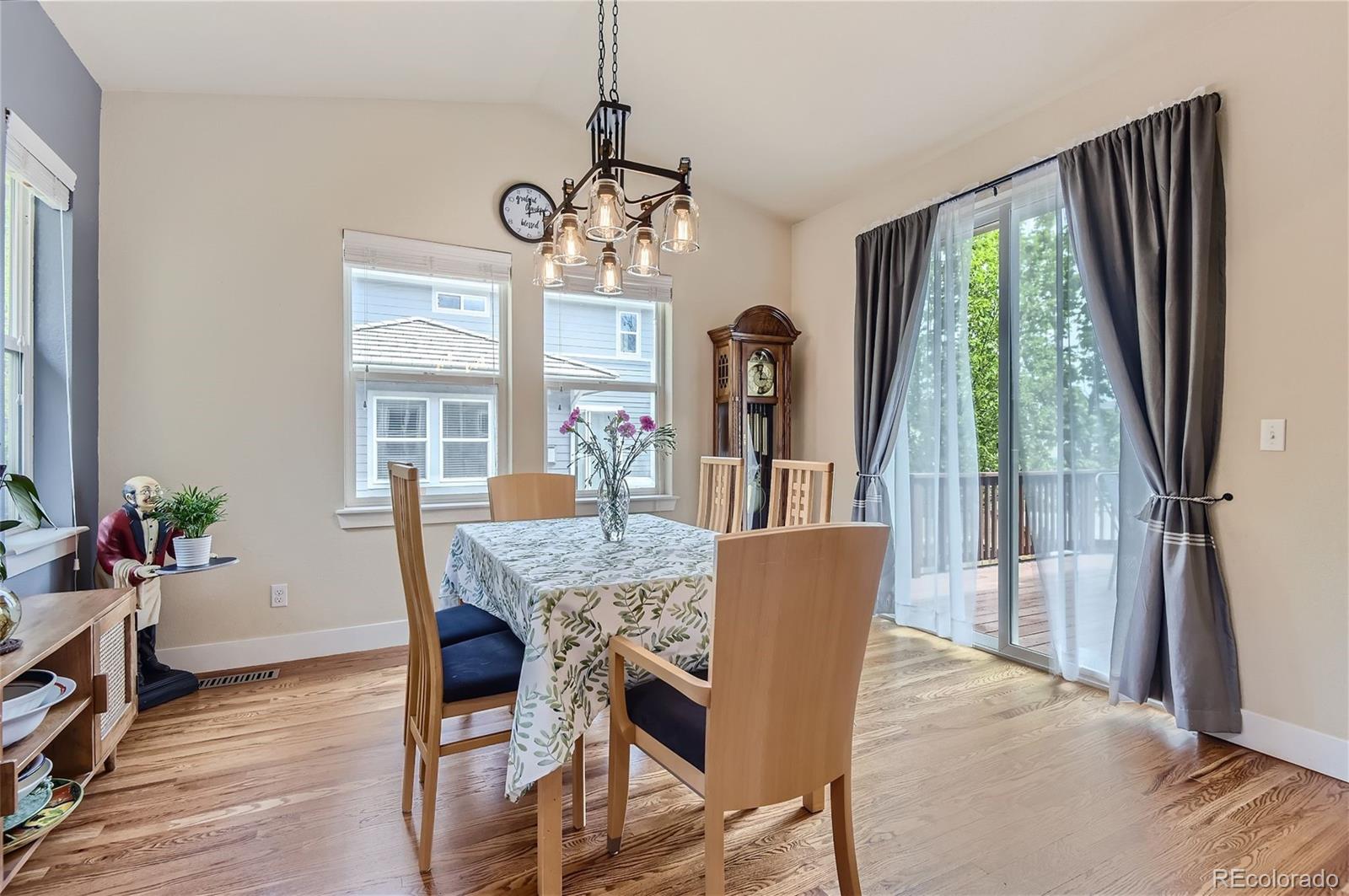 10495 Rutledge Street Parker, CO 80134 - Photo 11 of 32 a view of a dining room with furniture window and wooden floor