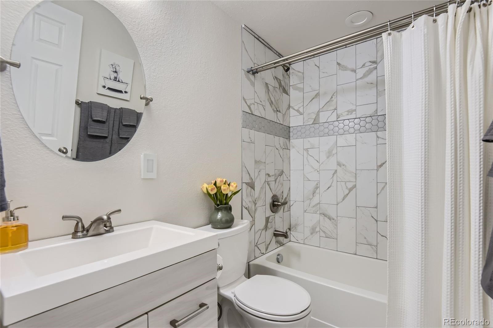 10495 Rutledge Street Parker, CO 80134 - Photo 26 of 32 a bathroom with a sink a toilet and shower